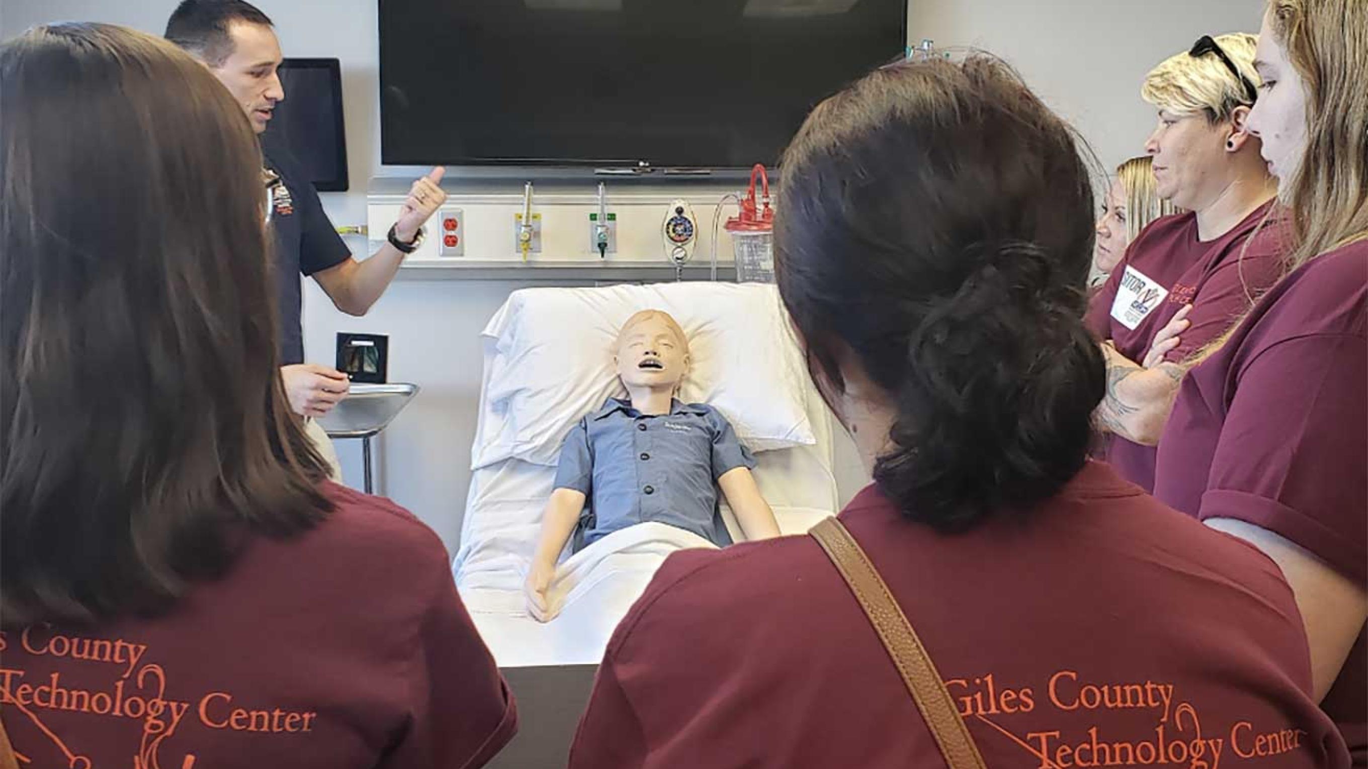 High school students gathered in a simulation center room