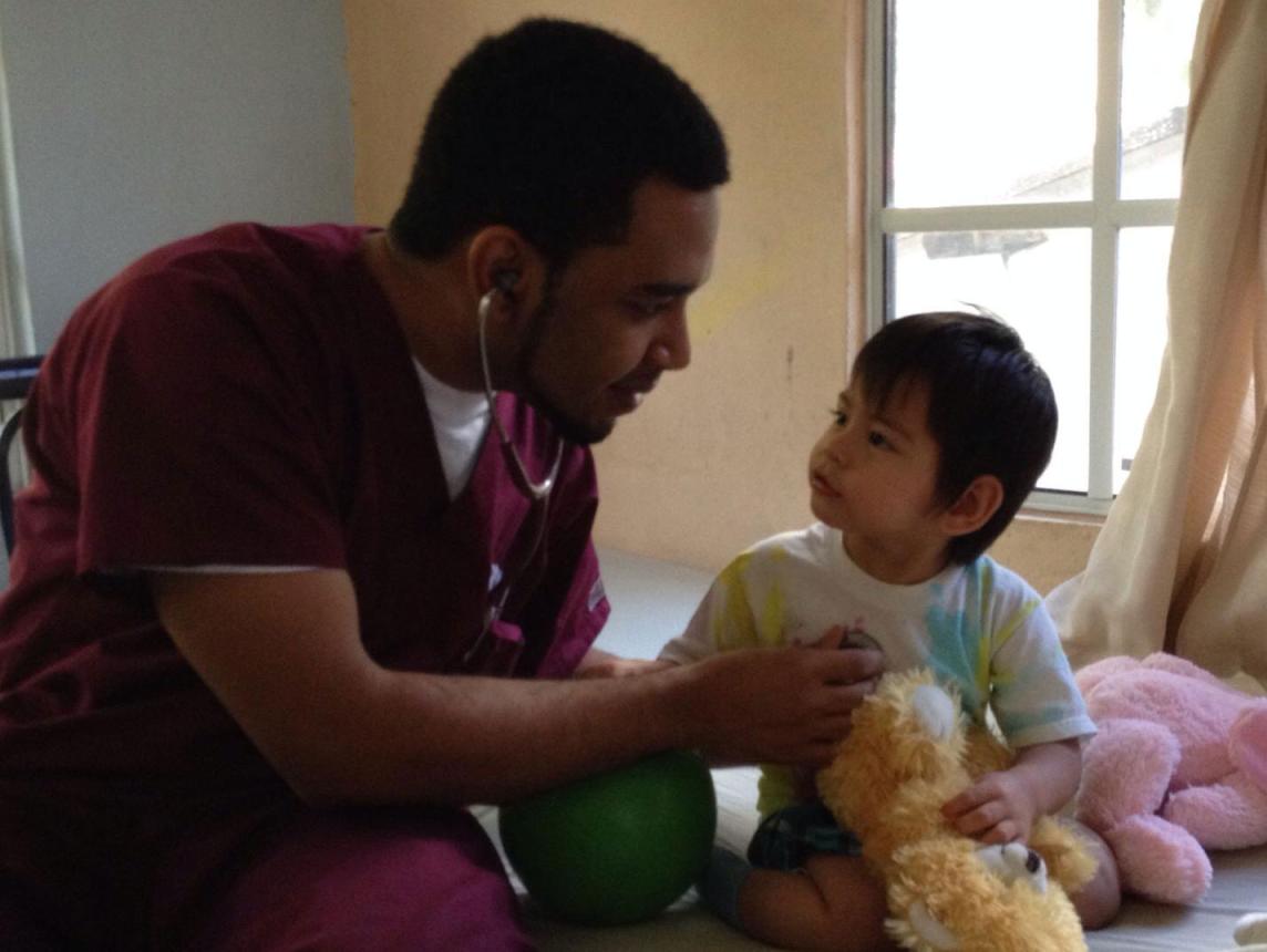Amar treating a small child on a mission trip