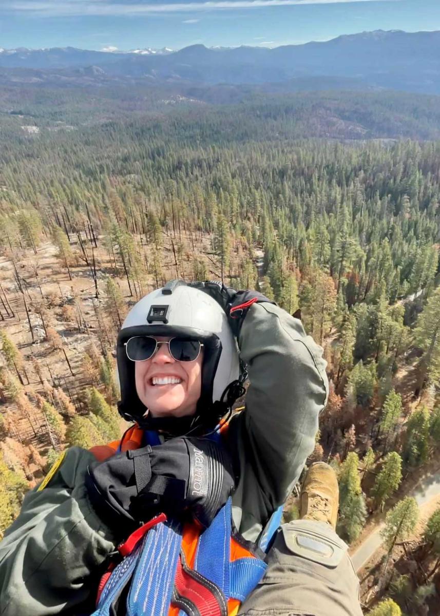 Taylor Rudolph parachuting over a mountainous area