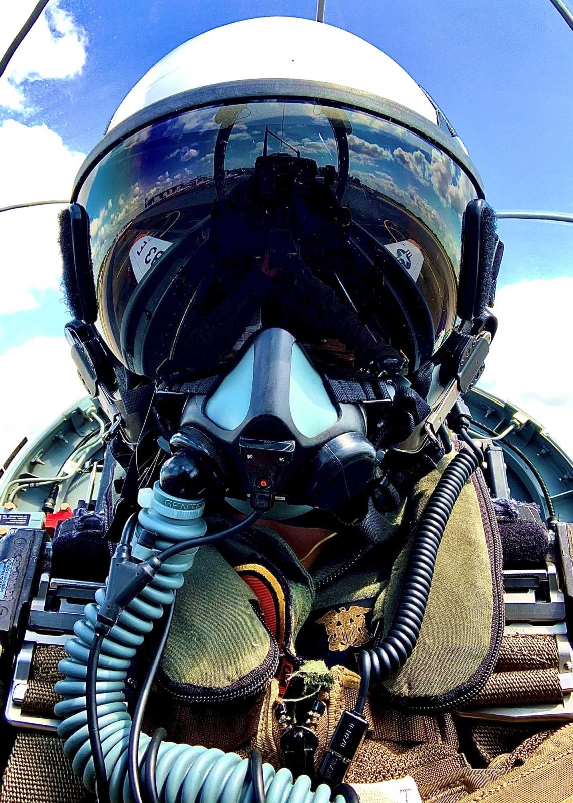 Taylor Rudolph wearing helmet in jet cockpit while flying