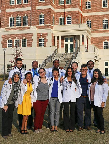Auburn students in white coats