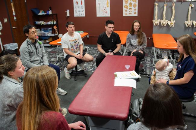 VCOM-Carolinas students sitting in a circle discussion