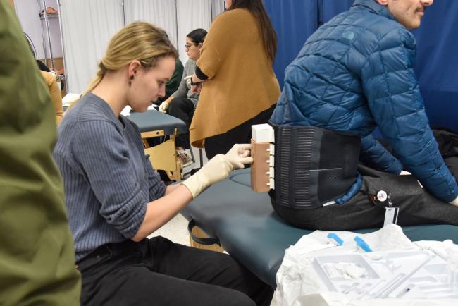 Student practicing epidural in simulation center