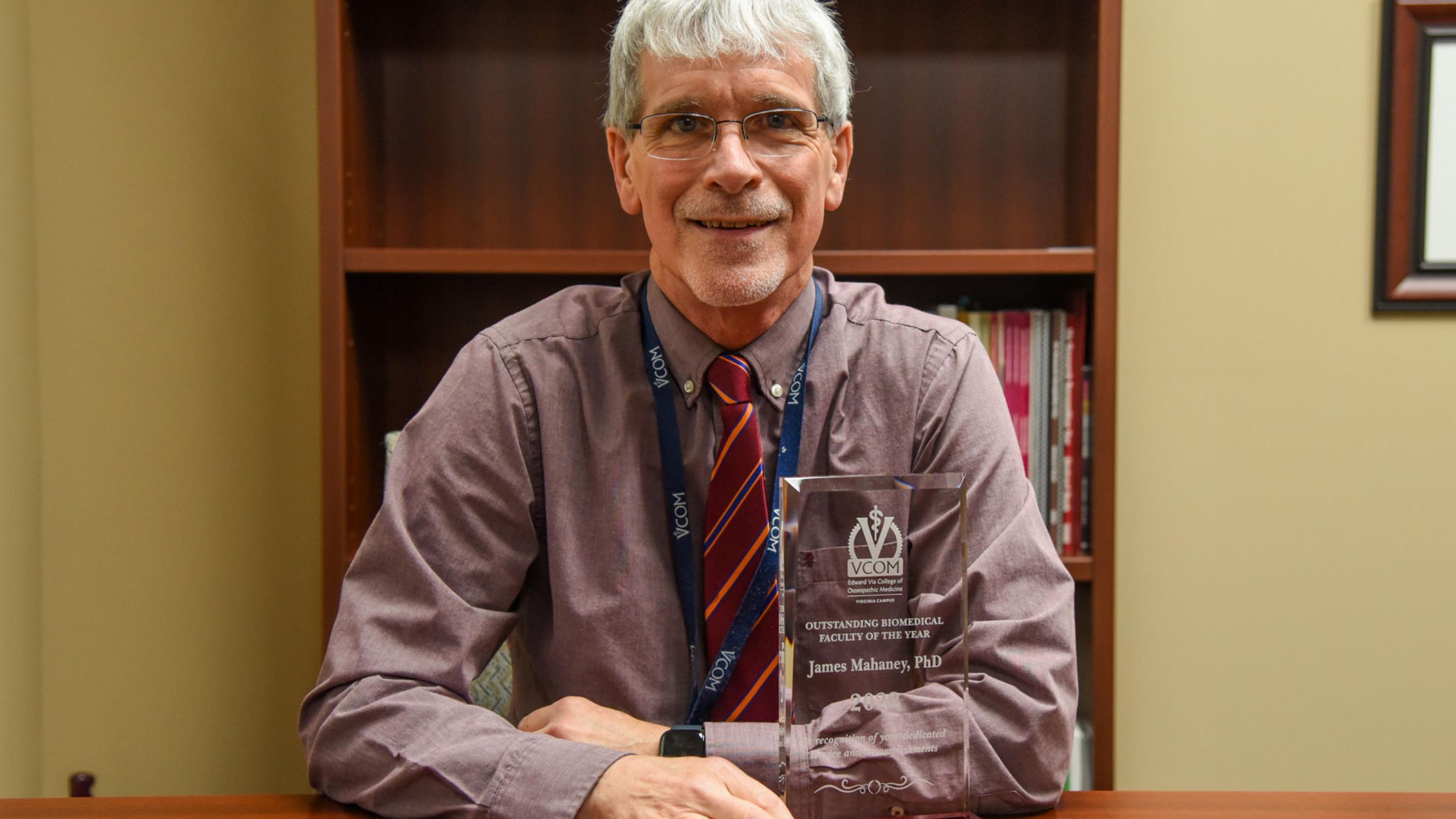 Jim Mahaney posing with award