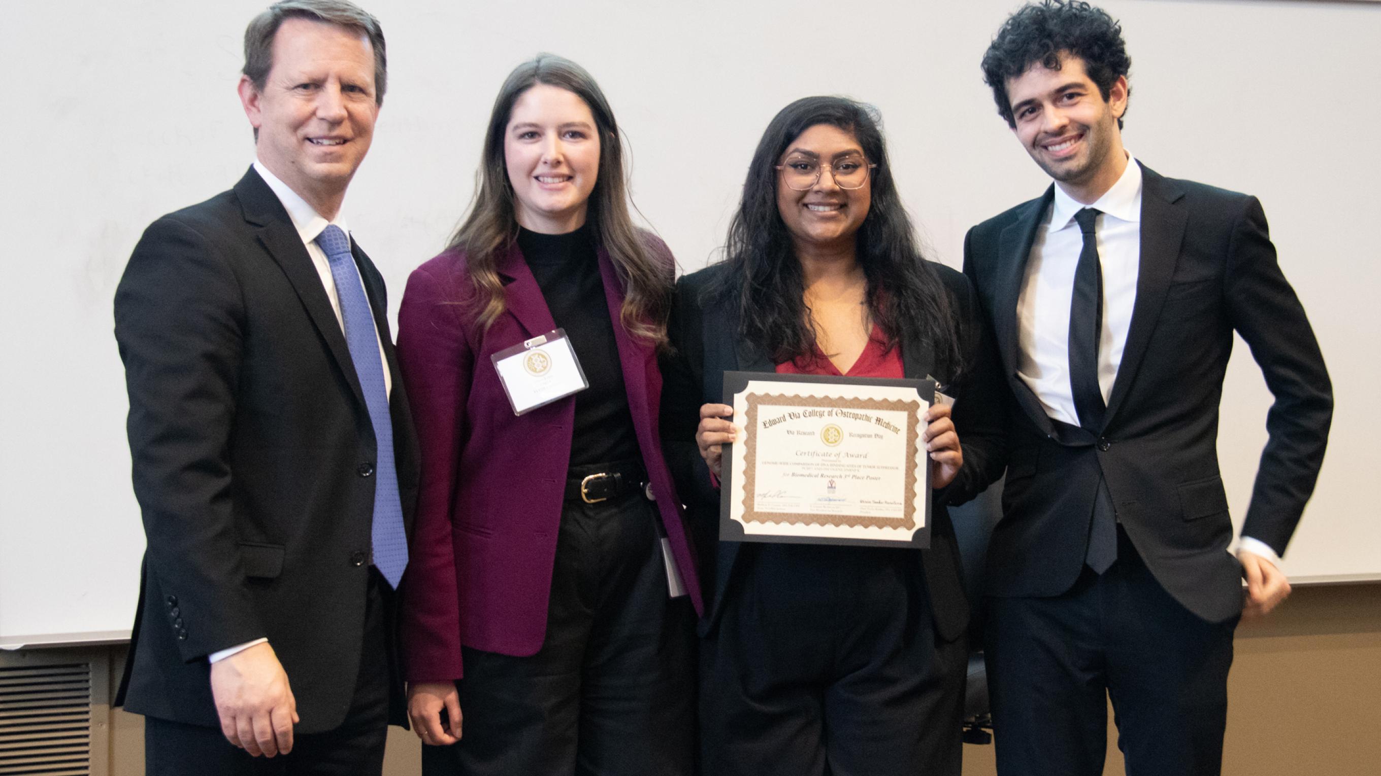 Students and faculty on Research Day posing with an award winner