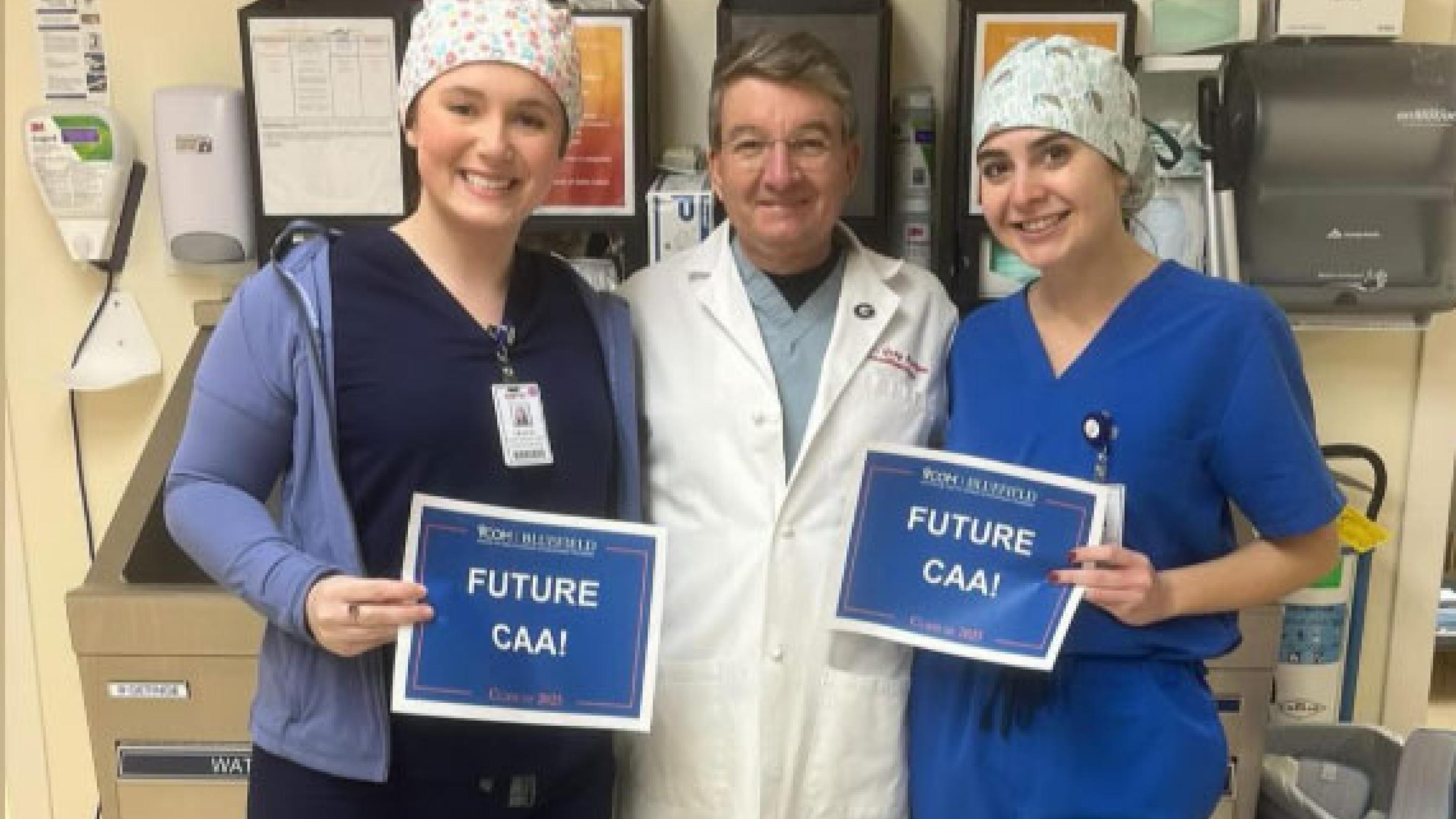 Two CAA students with a doctor smiling