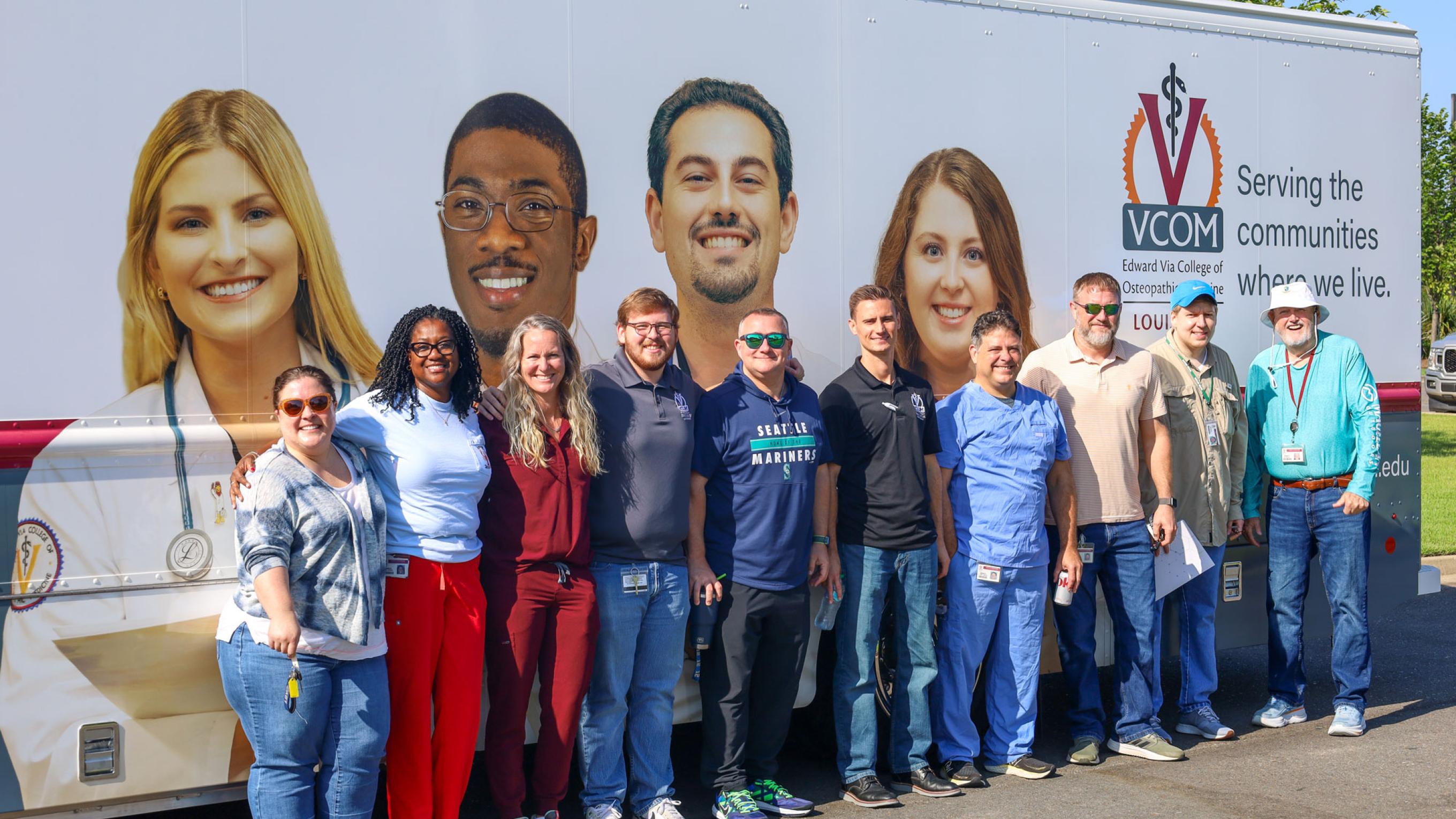 VCOM-Louisiana faculty and staff standing in front of a mobile medical unit