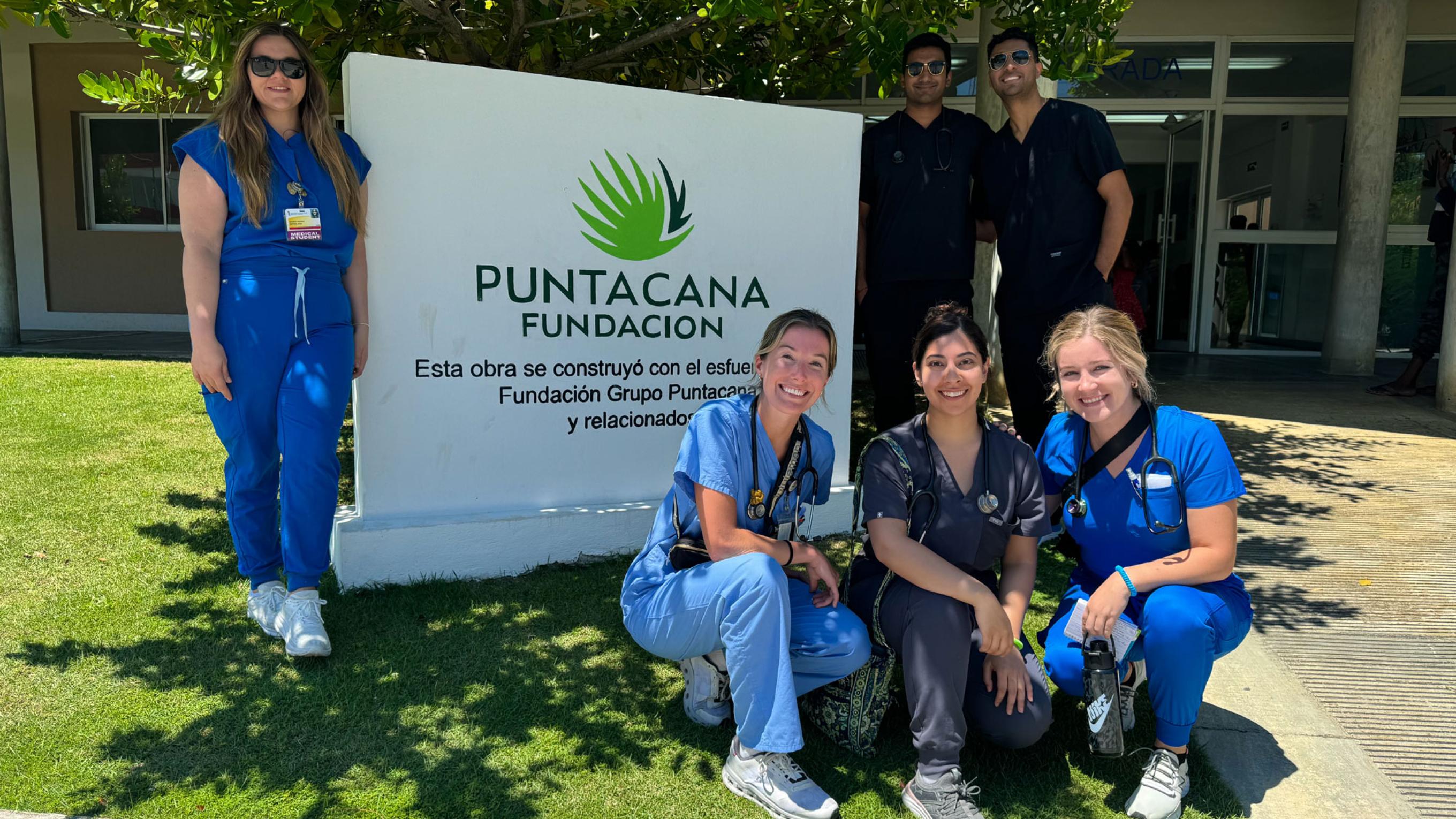 VCOM-Louisiana students posing in front of the Punta Cana clinic sign