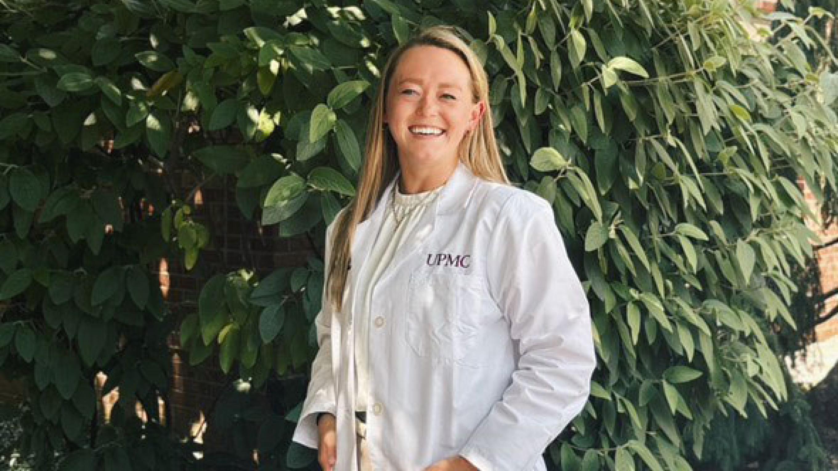 Kristina Alexander, DO smiling in her white coat