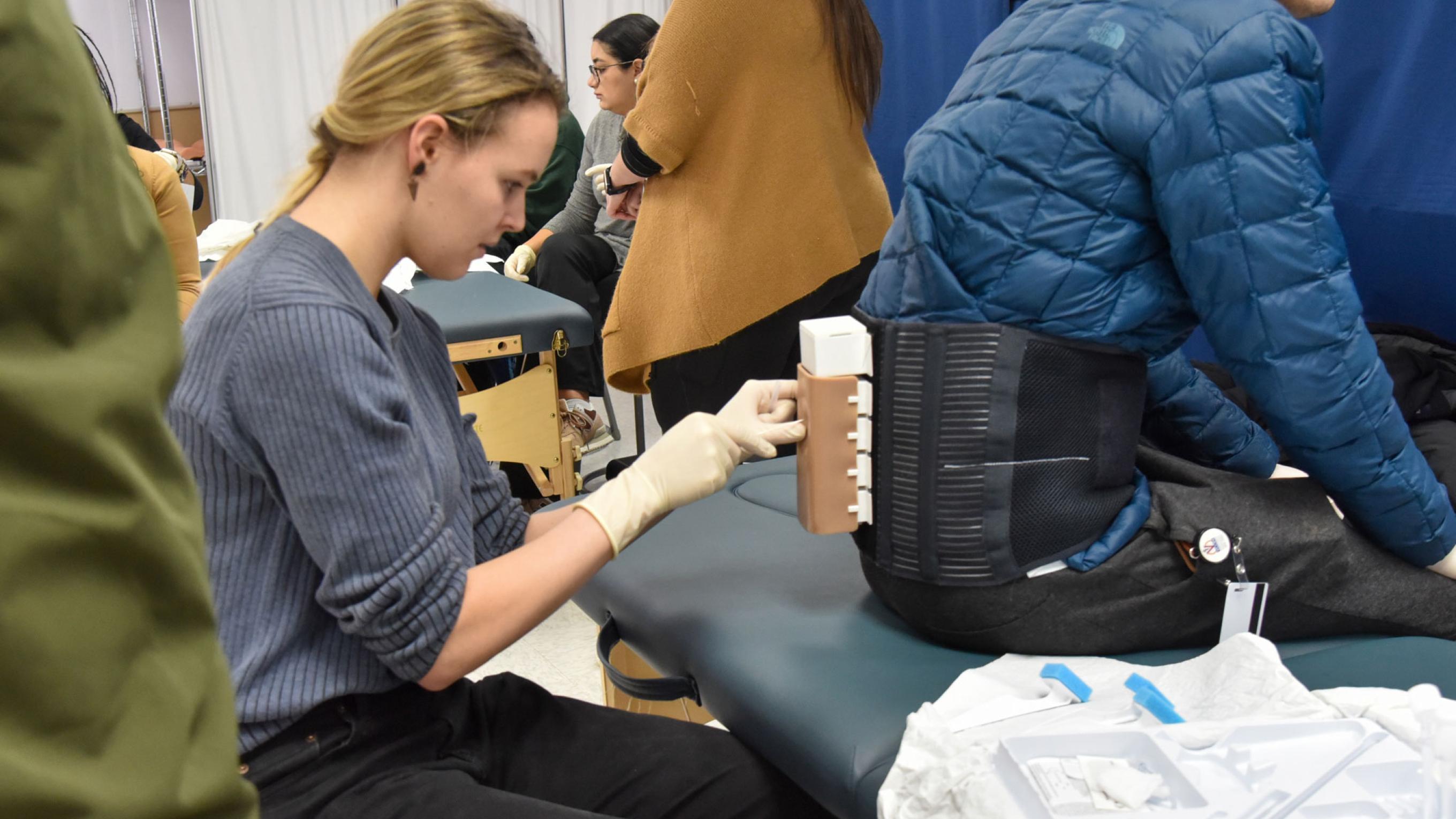 Student practicing epidural in simulation center