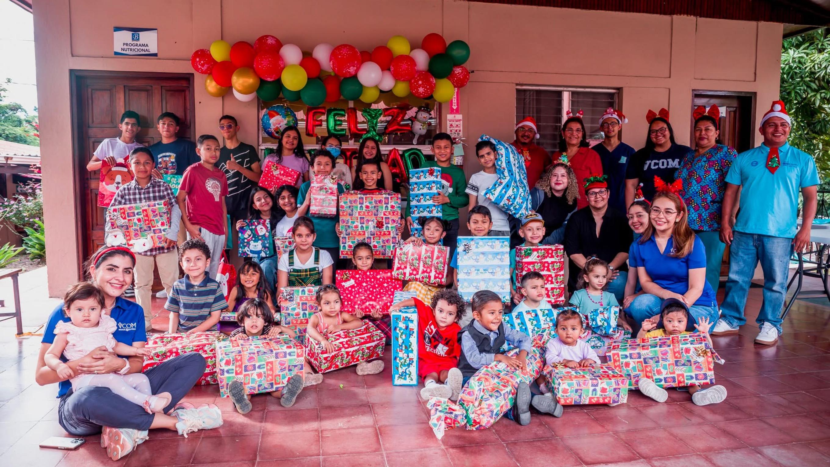 Large group of children in Honduras holding gifts and smiling