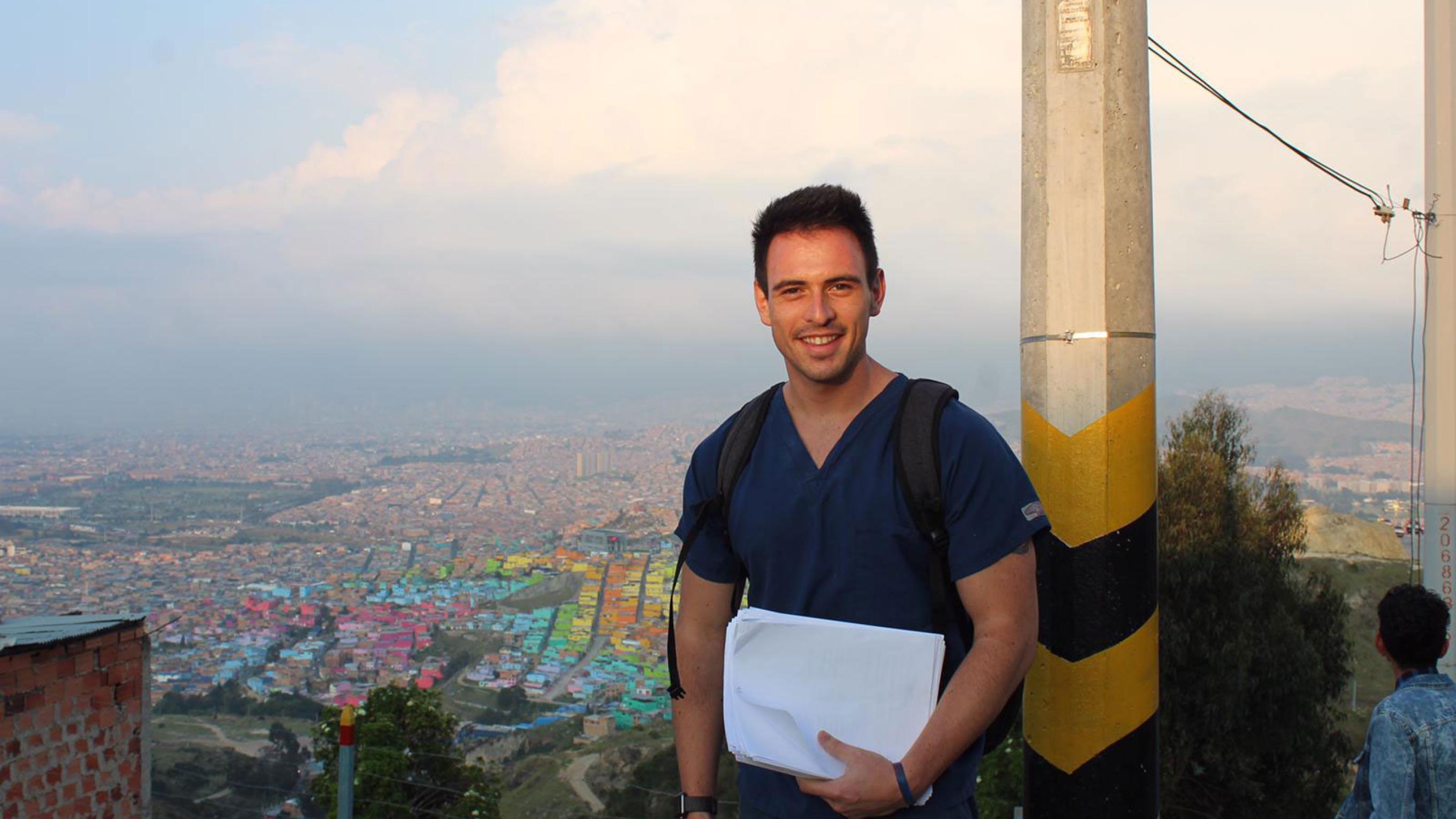 Robert Eysler on a mission trip with a view of the city behind him