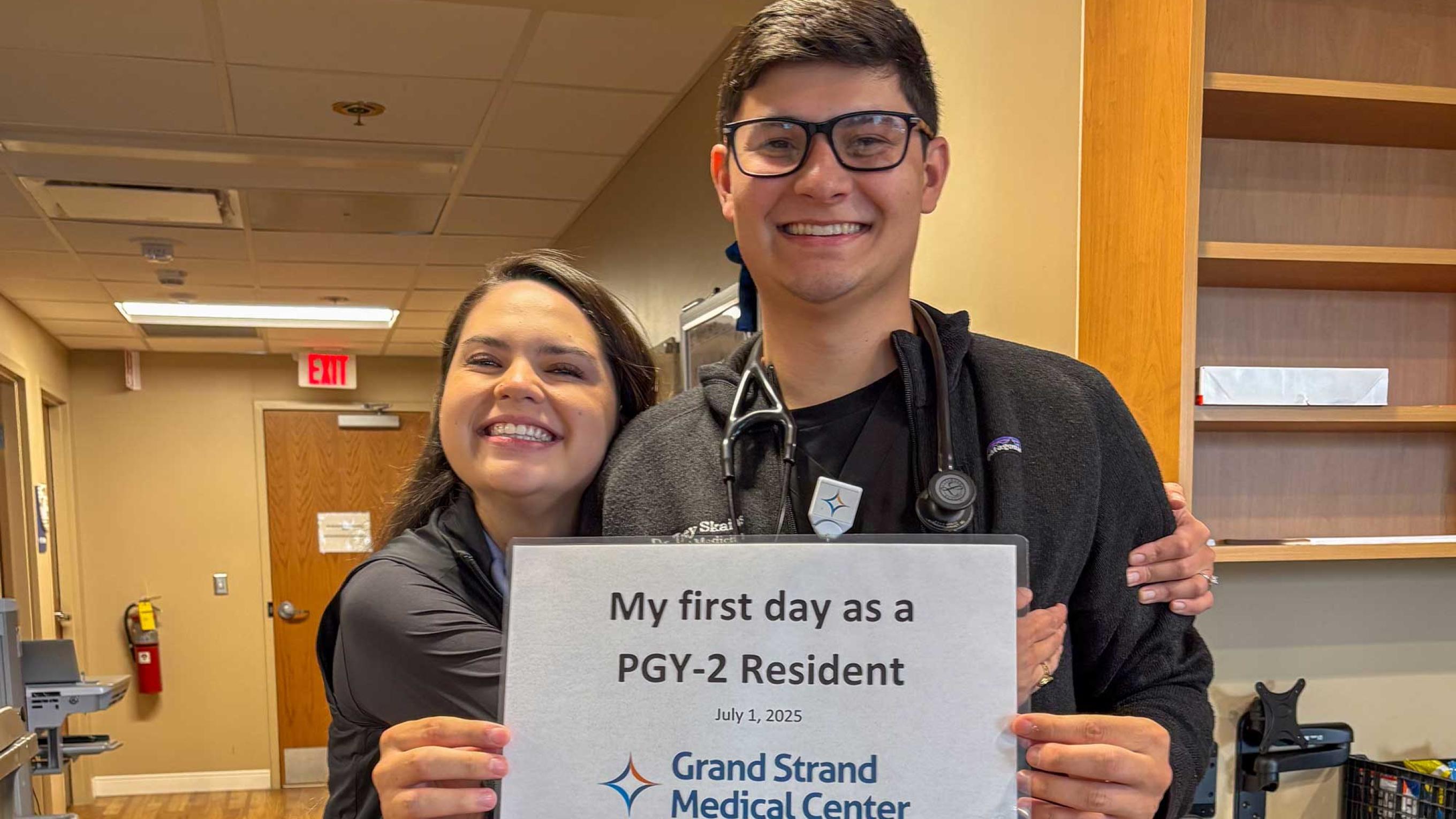 Trey Skains holding his PGY-2 resident sign