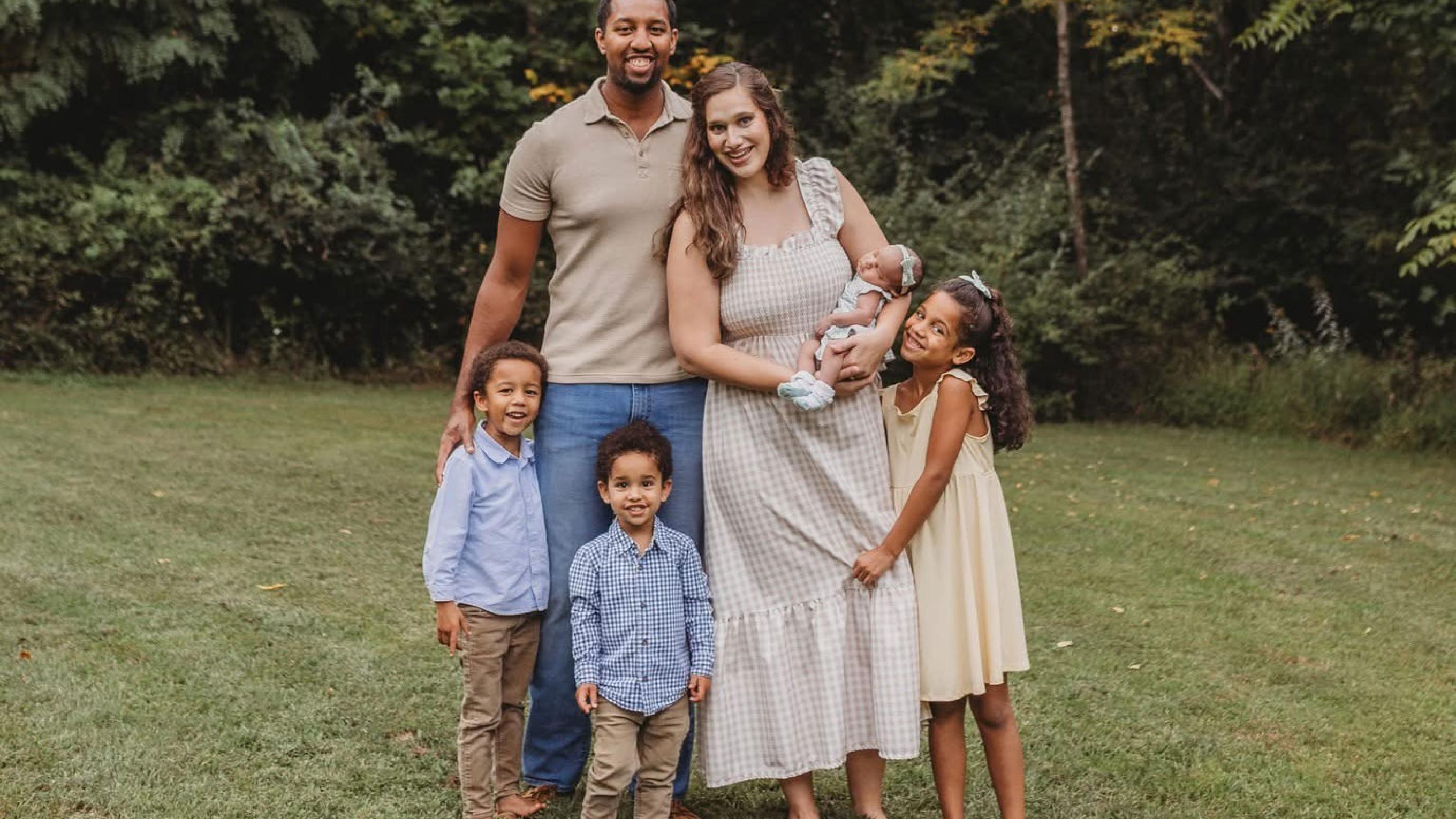 Jordan Saunders with his wife and children outside smiling