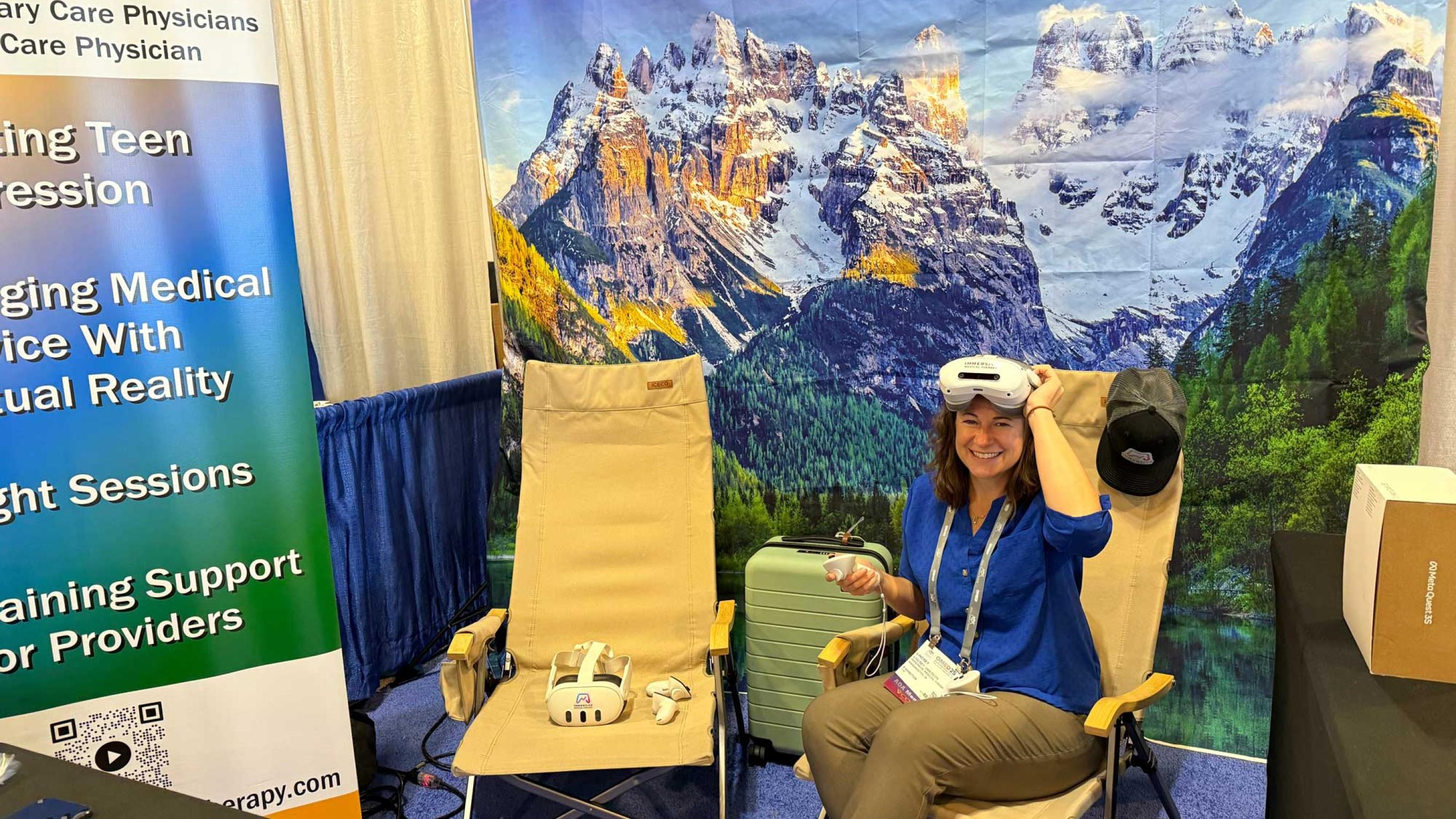 Lindsey Van Duyn wearing VR goggles sitting in a chair