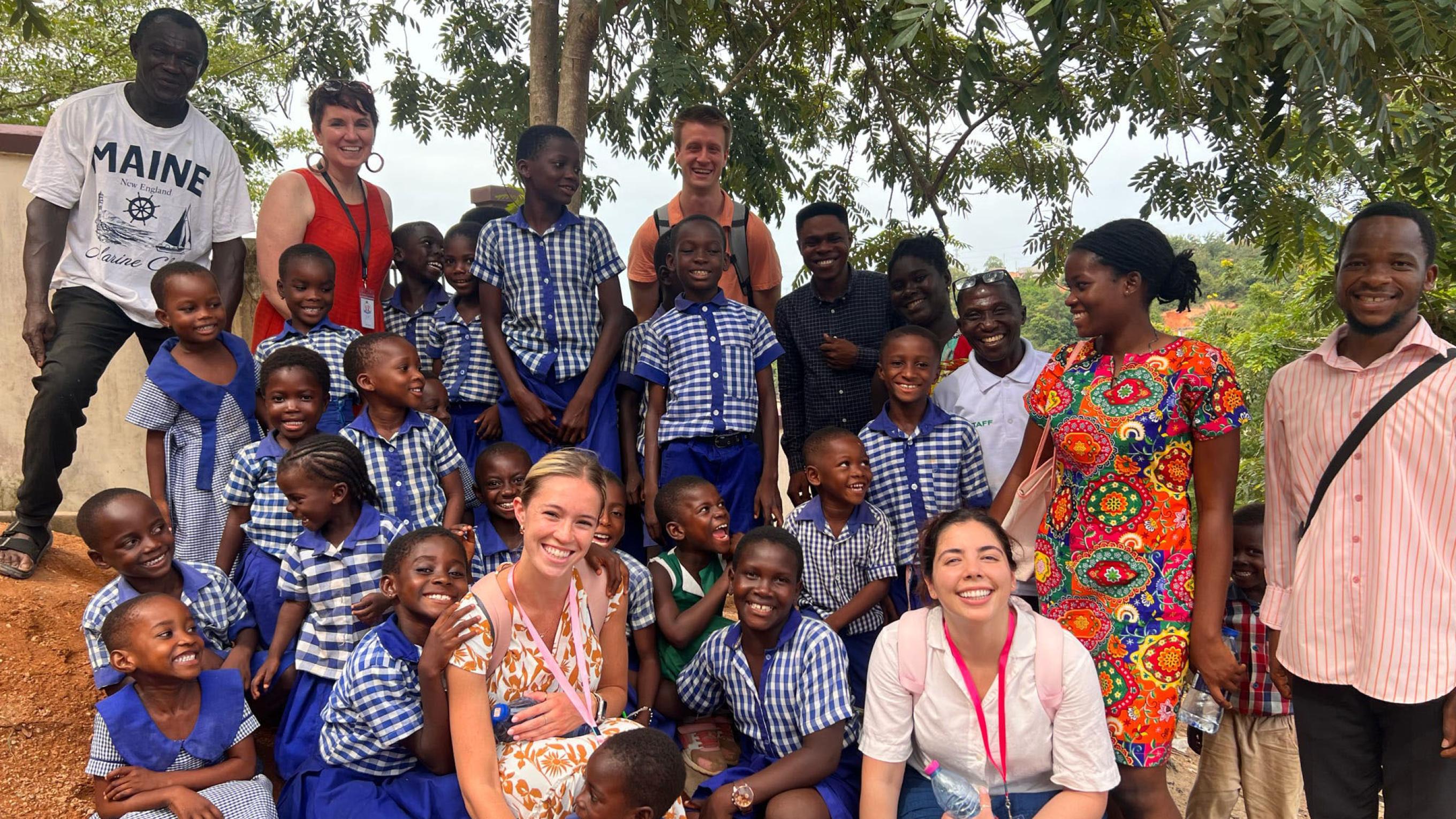 VCOM medical students with a large group of children in Ghana
