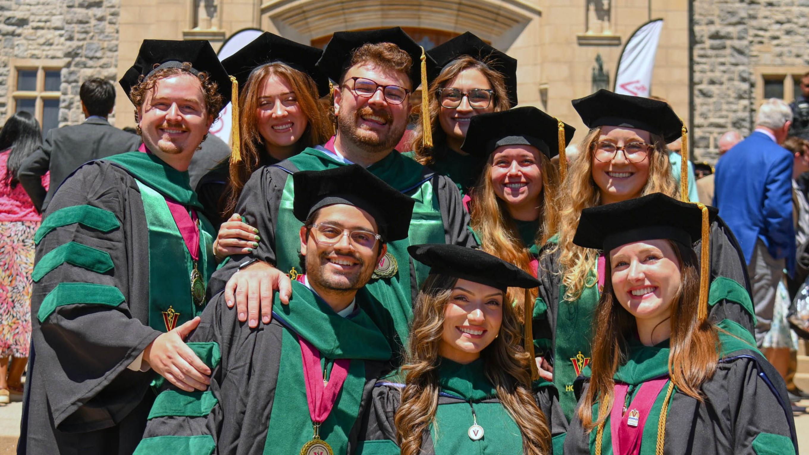 Large group of VCOM-Virginia 2026 graduates in regalia smiling