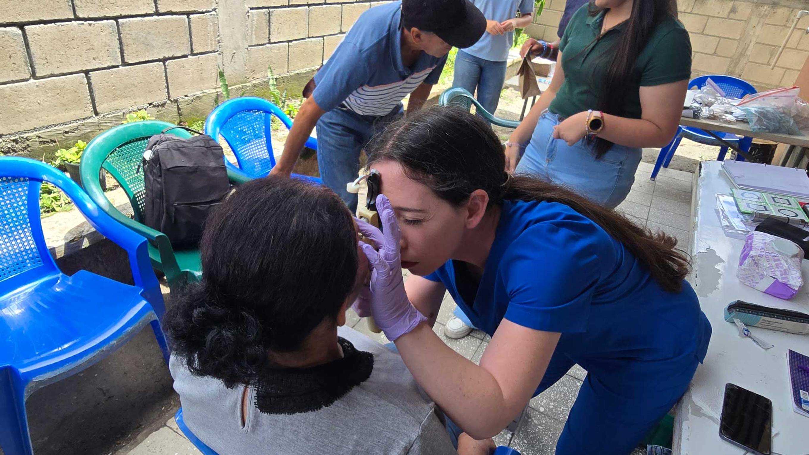 Student doctor examining a patient's eye