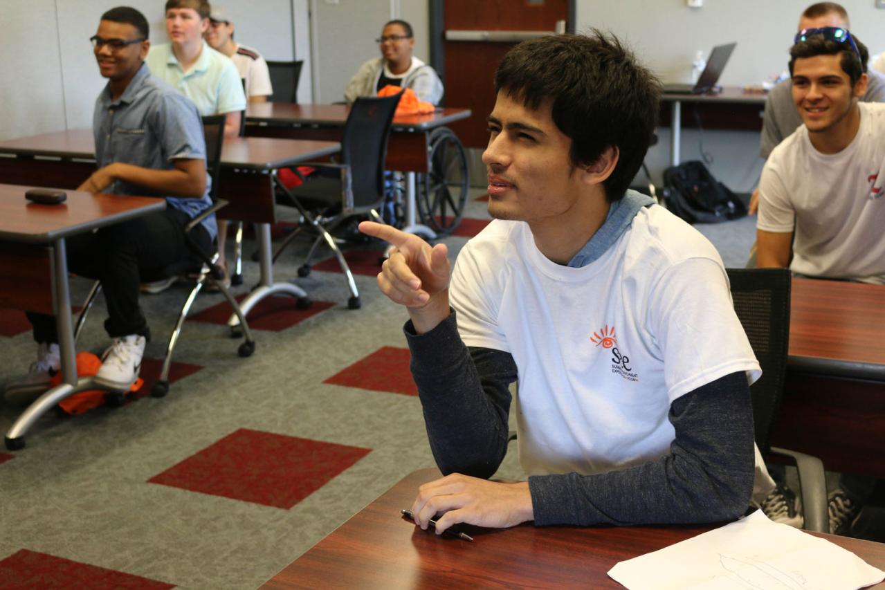 SEE camp student in classroom asking question