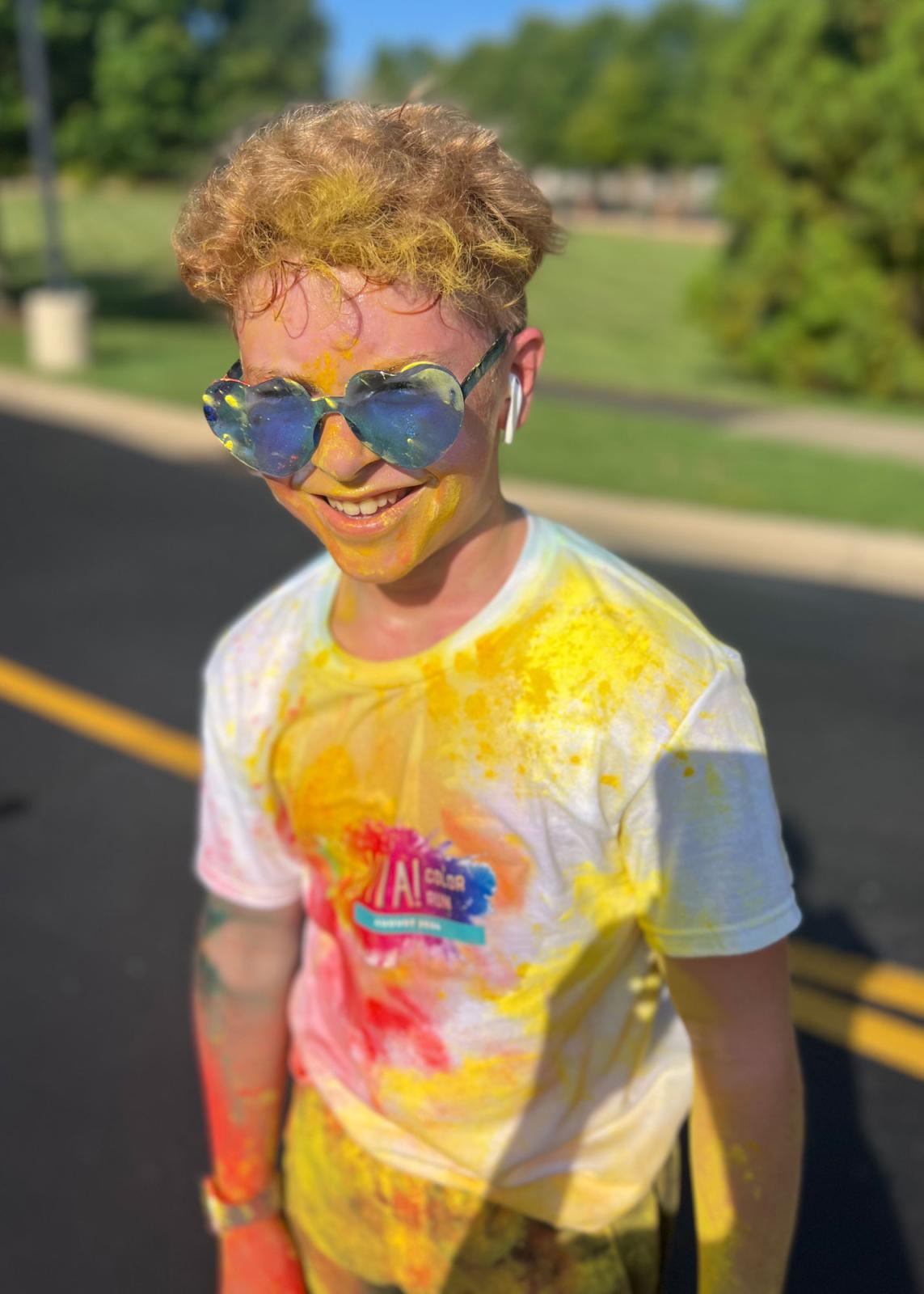 Runner wearing sunglasses covered in color