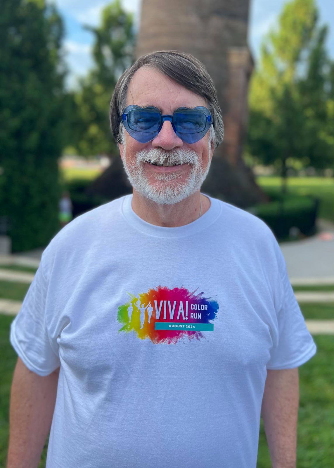 Man with heart-shaped glasses posing in color run t-shirt