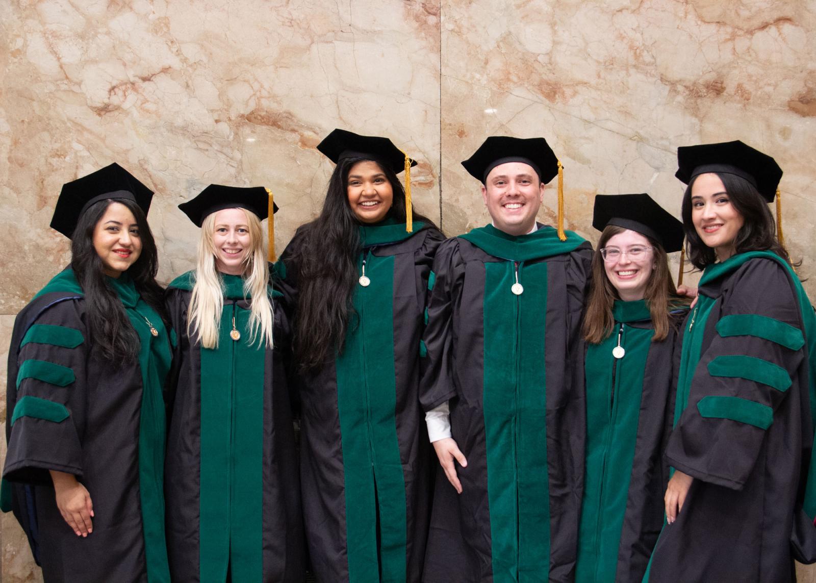 VCOM class of 2025 graduates in regalia smiling