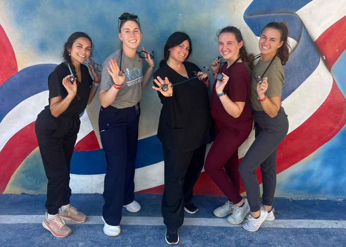 VCOM medical students posing with their stethoscopes smiling