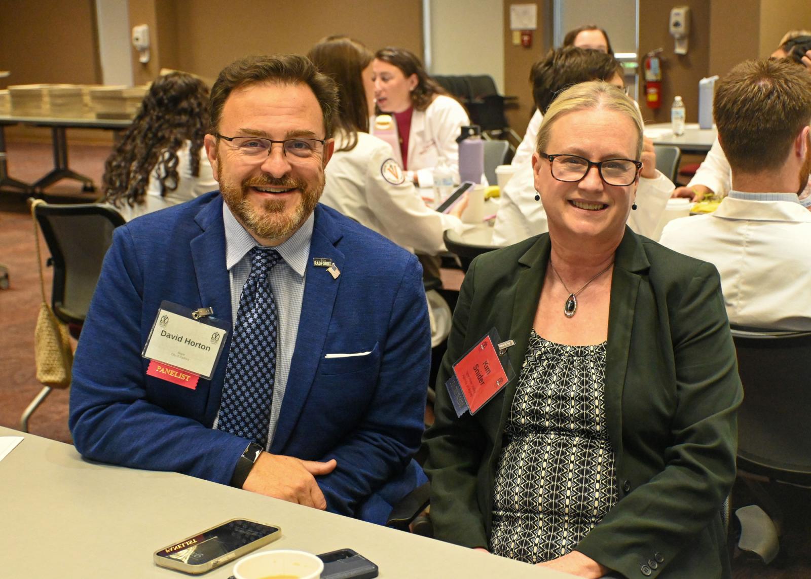 Two CORE symposium attendees smiling