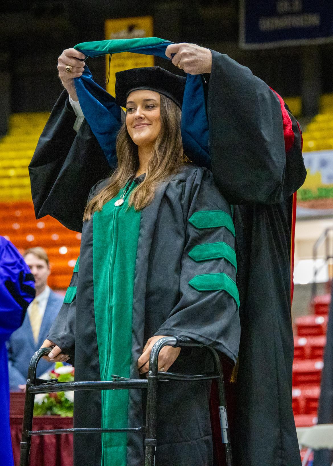VCOM-Louisiana class of 2026 graduate being hooded on stage