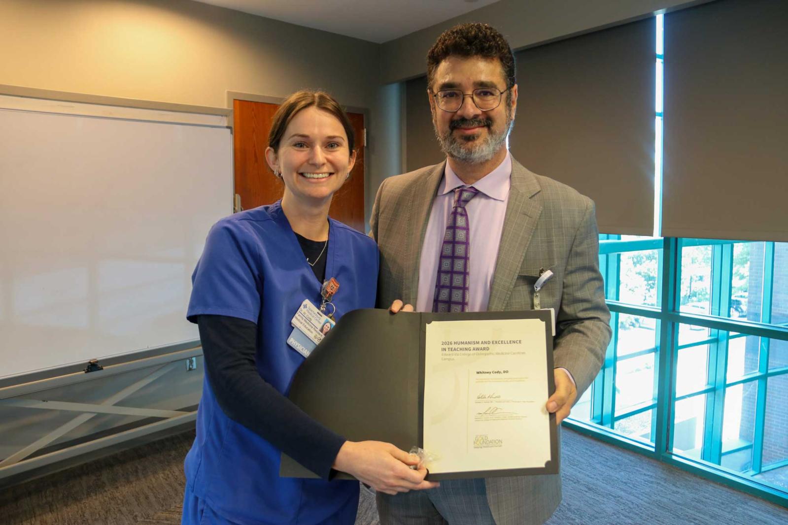 Dr. Sahhar presenting Dr. Cody with a certificate