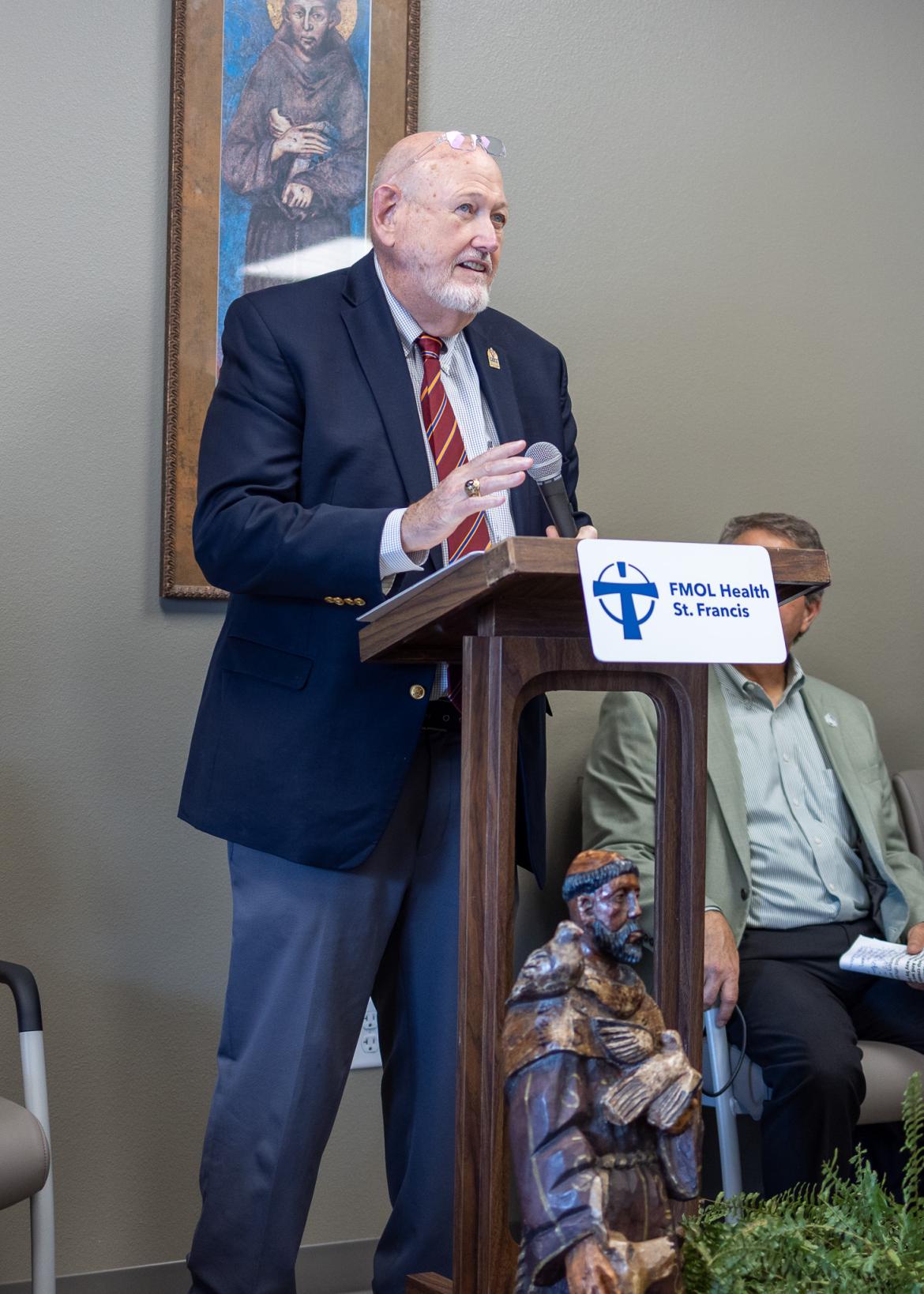 Person standing at a podium addressing the crowd