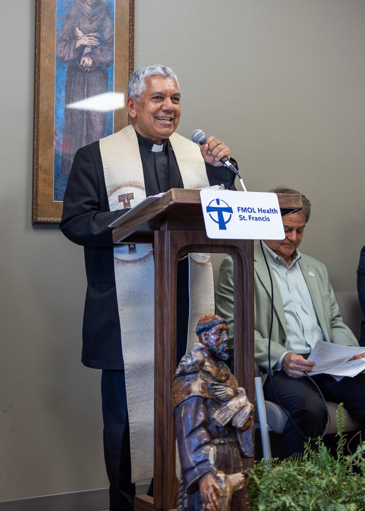 Person standing at a podium addressing the crowd