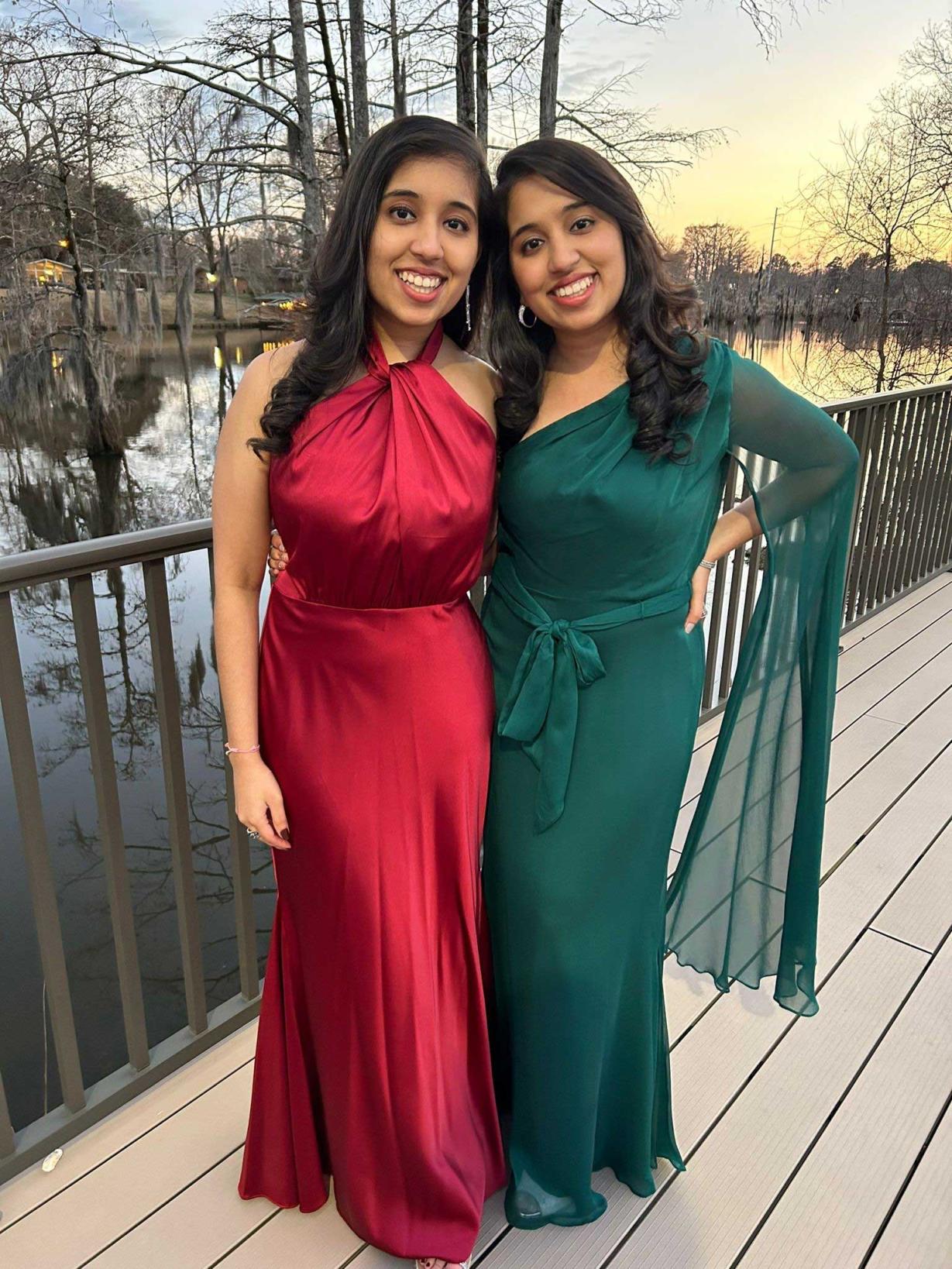 Drs. Ishani and Shivani Sharma in dresses smiling