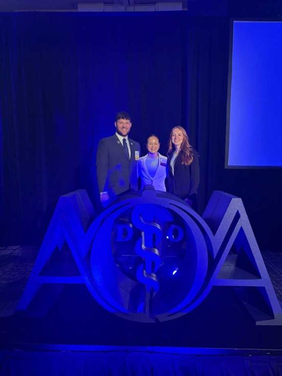 VCOM-Louisiana representatives smiling on stage