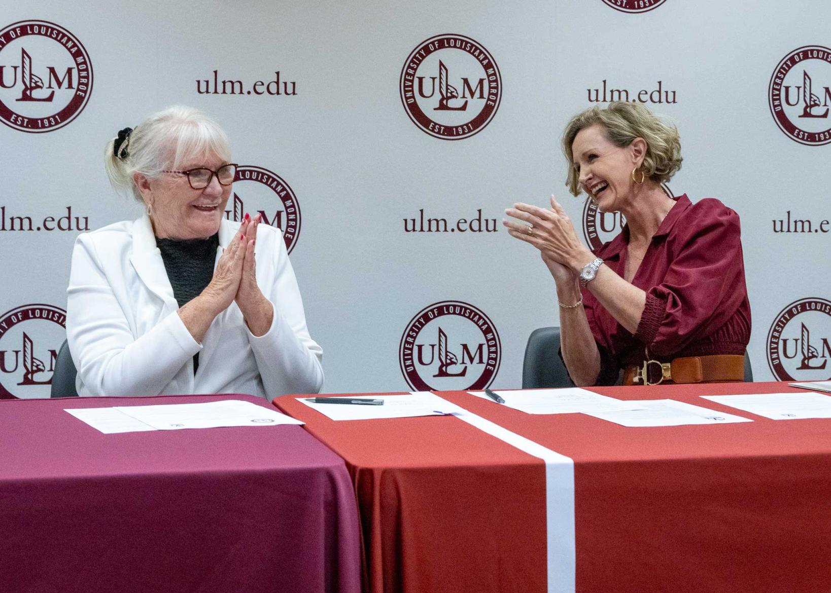 Dixie Tooke-Rawlins and Carrie L. Castille clapping and smiling