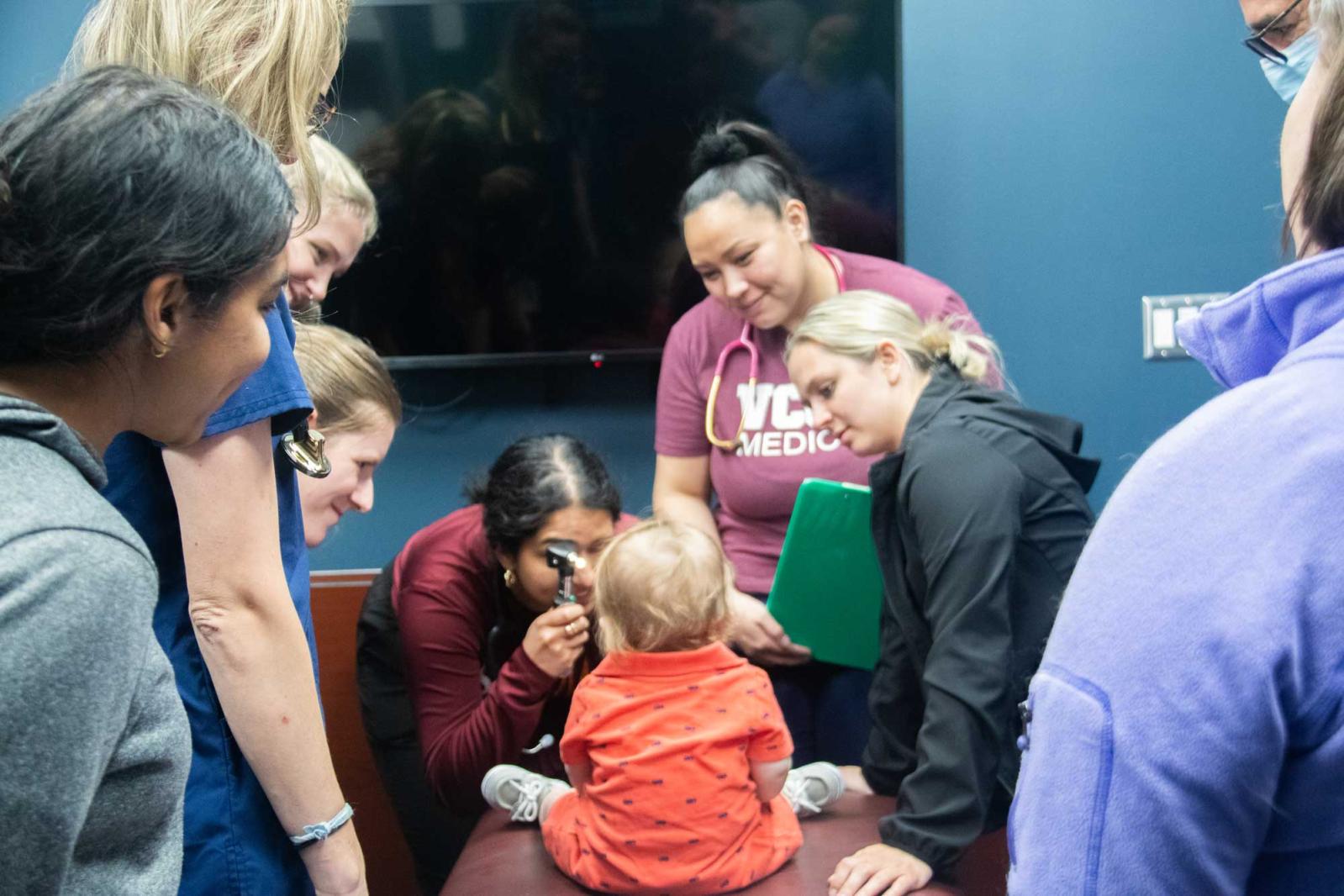 Medical students gathered around a pediatric patient