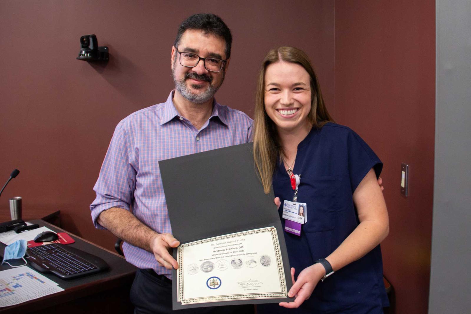 Dr. Sahhar with a medical student smiling