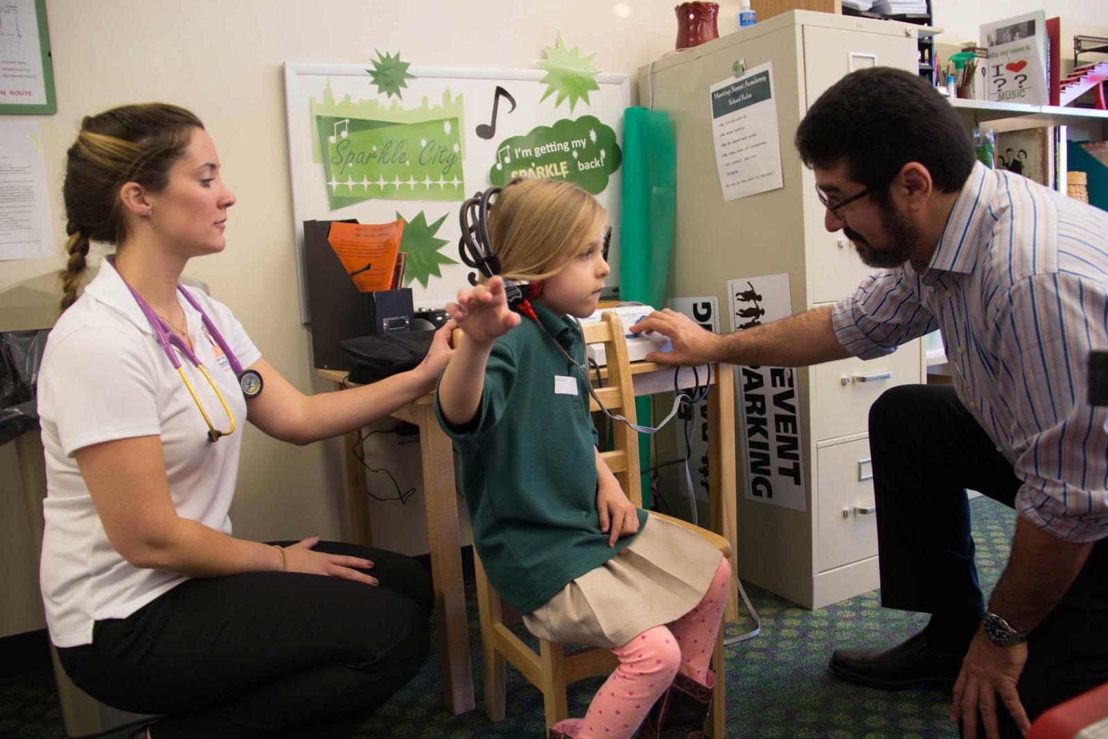 Dr Sahhar, a medical student, and a pediatric volunteer
