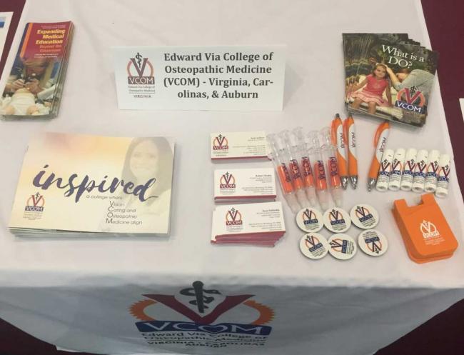 VCOM Branded Promotional Items on a Table