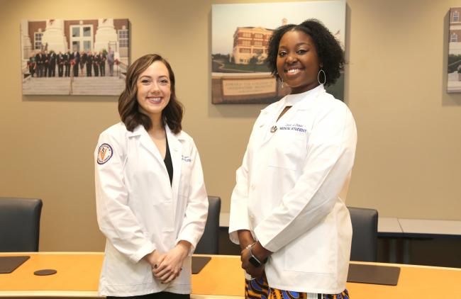 VCOM auburn students pose in their medical student white coats