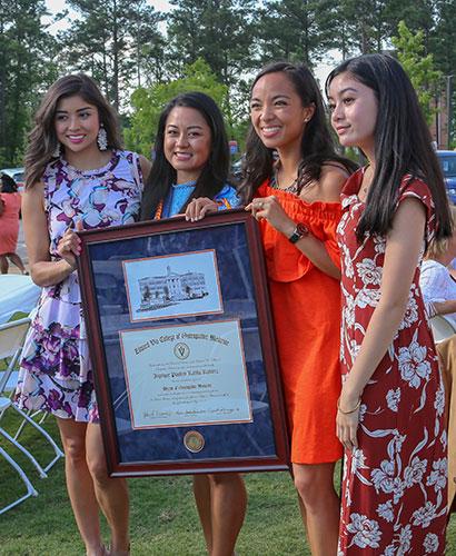 Graduates holding diploma