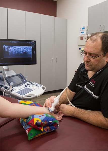 Dr. Kozar performing an ultrasound