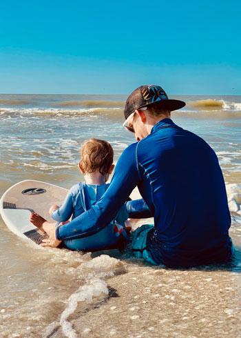 Paul Graham DO on a beach with son