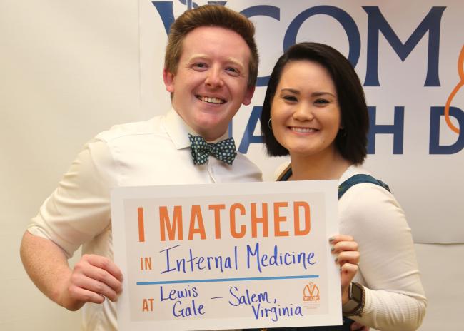 Auburn student holding match day sign