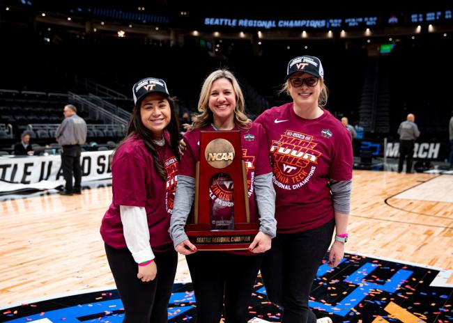 Mary Mitchell, DO posing with trophy after basketball game