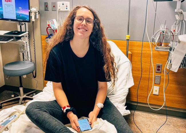 Ellie Greene sitting on a hospital bed
