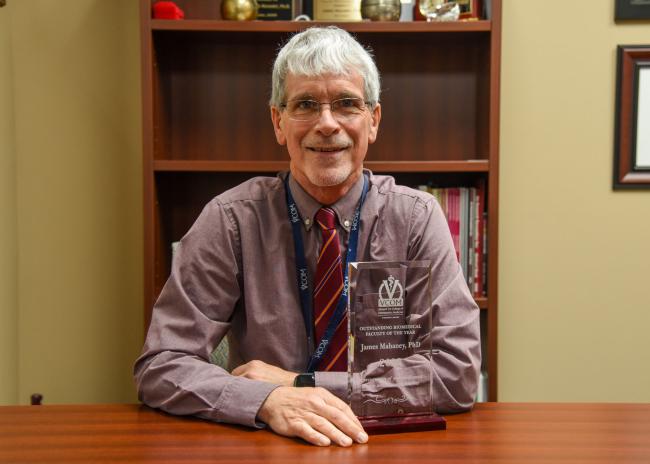 Jim Mahaney posing with award