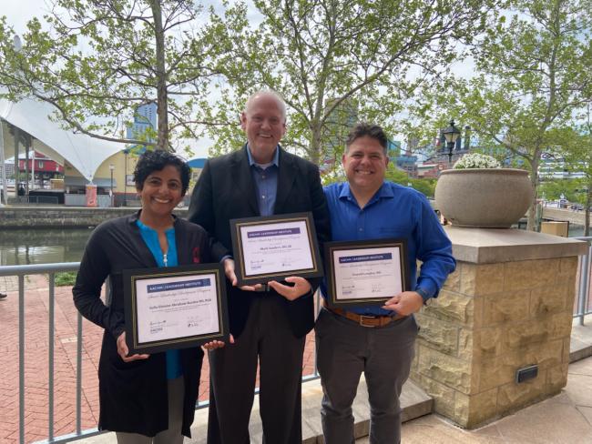 VCOM administrators posing with certificates