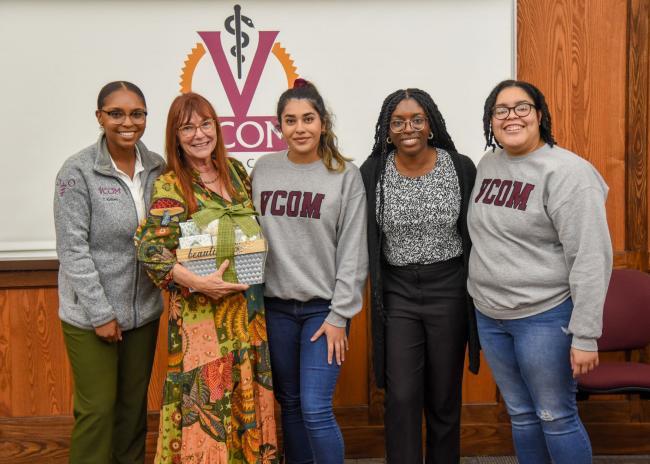 Dr. Willcox posing with students after a multicultural show