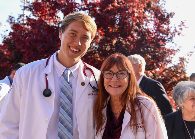 Dr. Willcox with student after a white coat ceremony